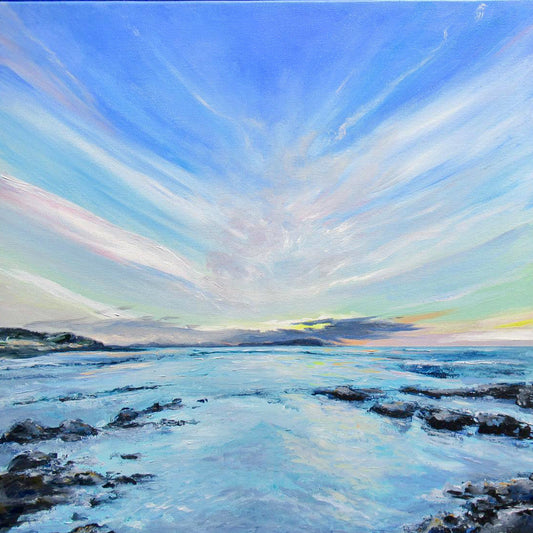 Vibrant early sunset over water and rocks