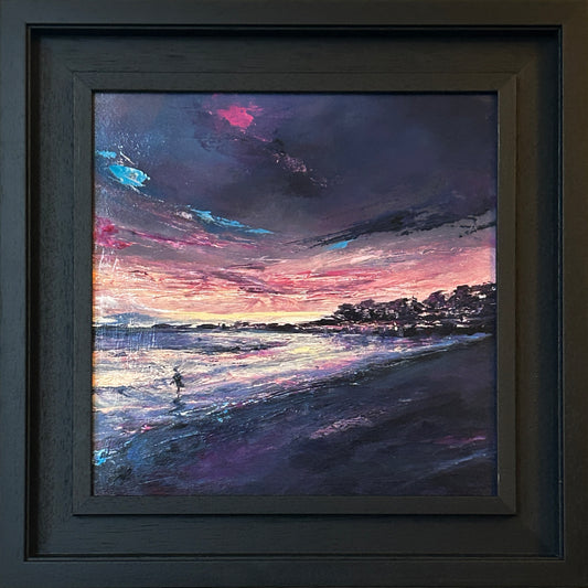 A framed seascape painting of a beach at dawn, featuring a dark, dramatic sky with pink, purple, and blue tones, a silhouetted shoreline, and a small figure of a swimmer leaving the water at Helens Bay. The artwork is enclosed in a dark wood frame.