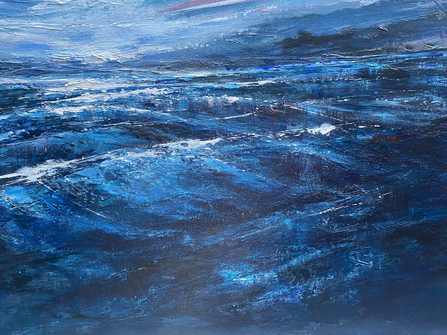 Acrylic painting of a stormy sea with dark blue and black tones.