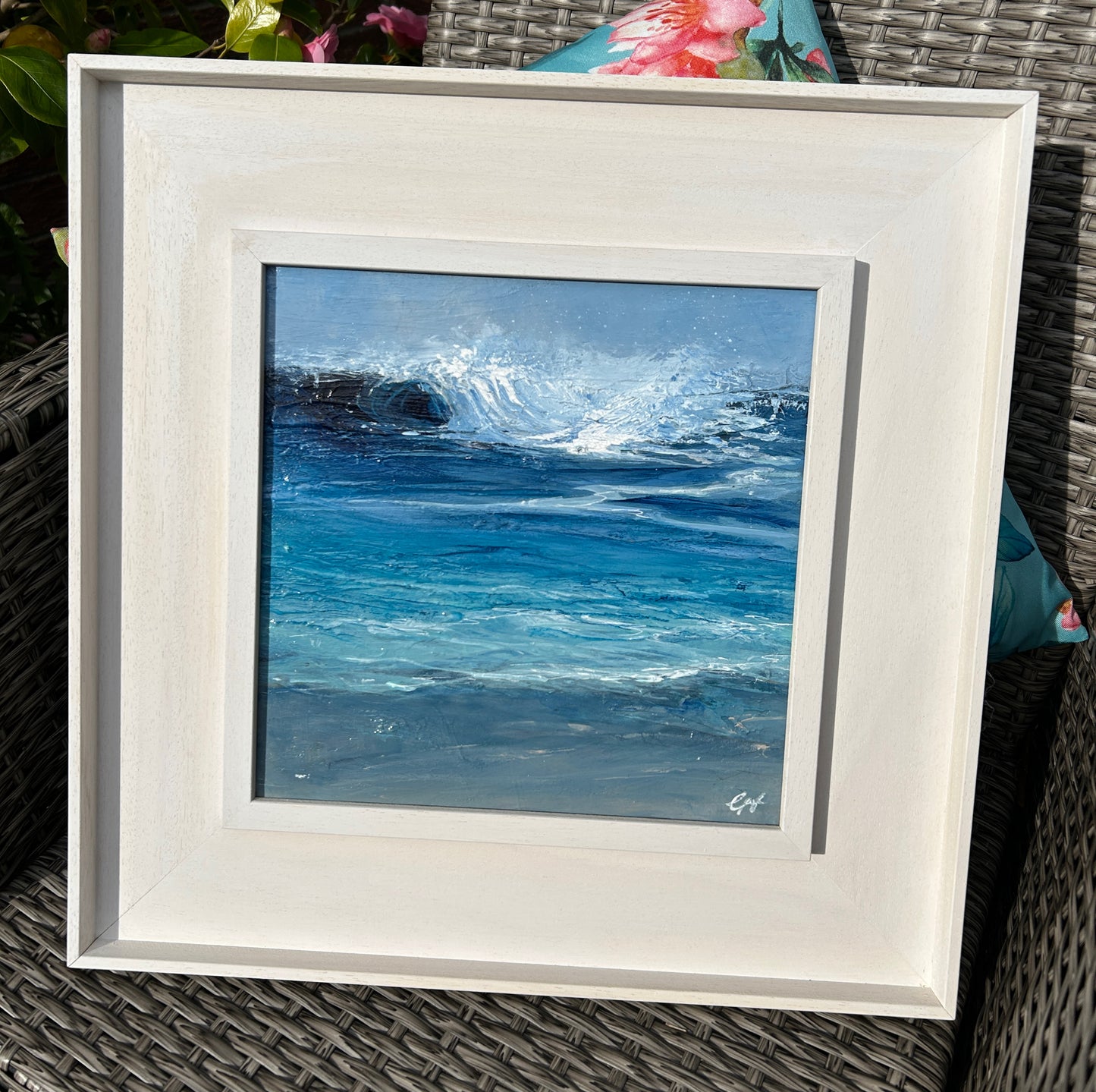 Framed painting of ocean waves on a textured surface