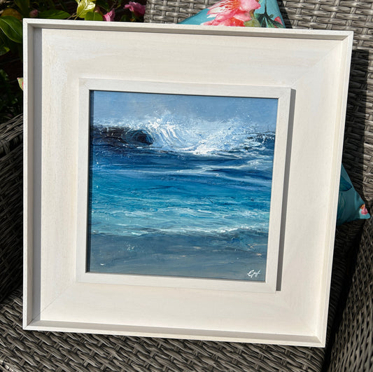Framed painting of ocean waves on a textured surface